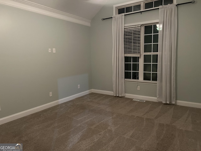 carpeted spare room with crown molding and vaulted ceiling