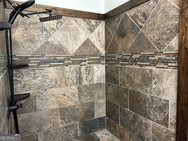 interior details featuring tiled shower