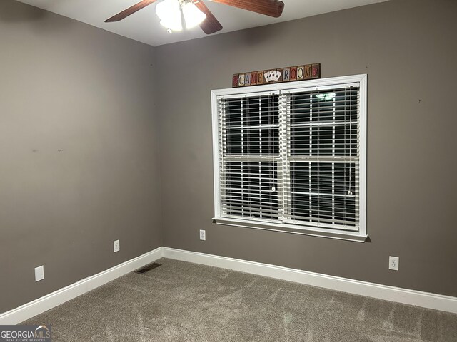 spare room with ceiling fan and carpet flooring