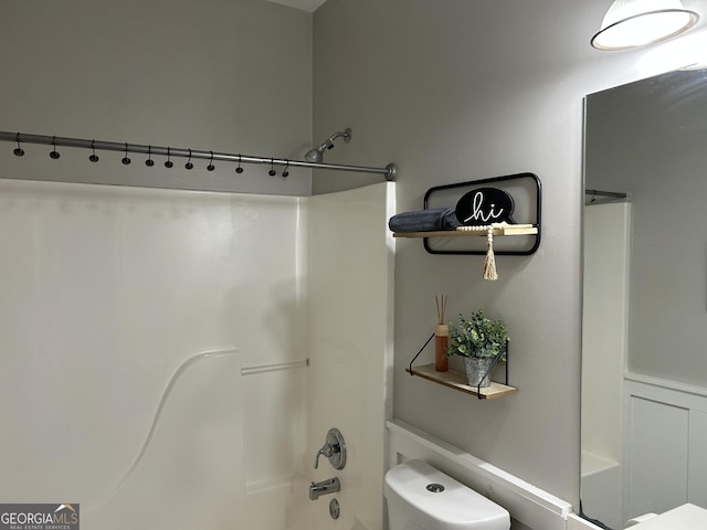 bathroom with toilet and bathtub / shower combination