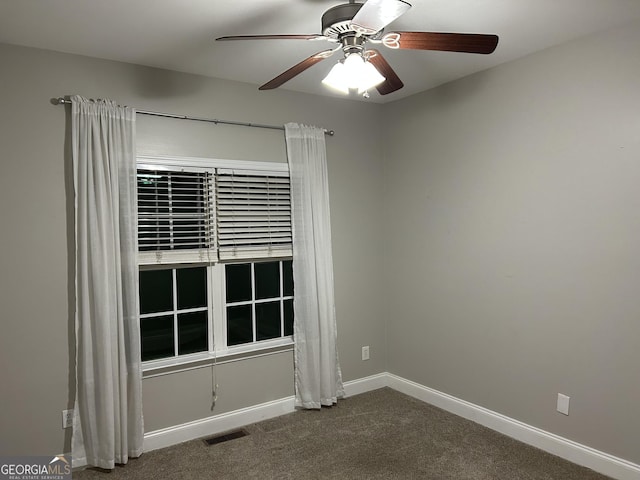 carpeted spare room featuring ceiling fan