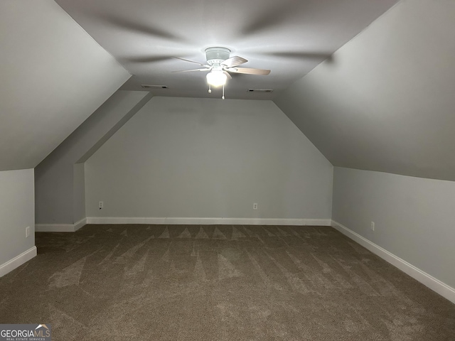 bonus room with lofted ceiling, ceiling fan, and dark colored carpet