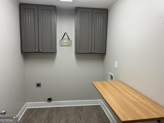 washroom featuring cabinets, dark wood-type flooring, hookup for a washing machine, and hookup for an electric dryer