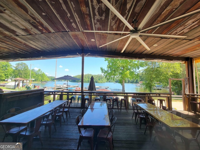 wooden deck featuring a water view and ceiling fan