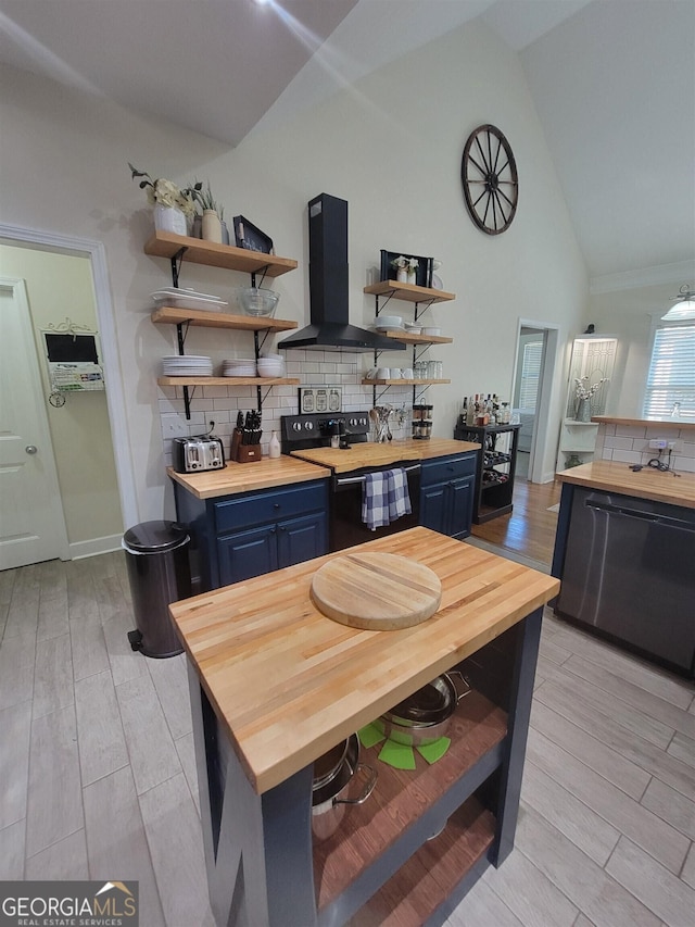 kitchen featuring blue cabinetry, black appliances, butcher block counters, and exhaust hood