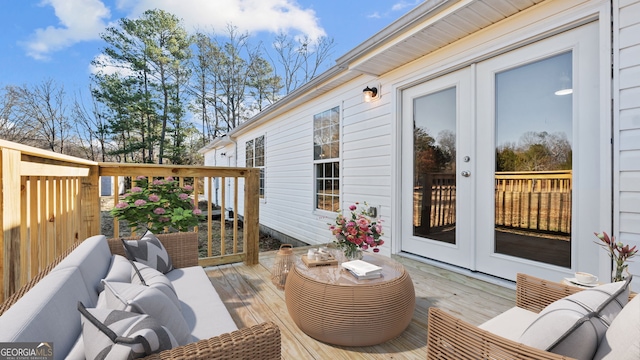 wooden deck featuring outdoor lounge area and french doors