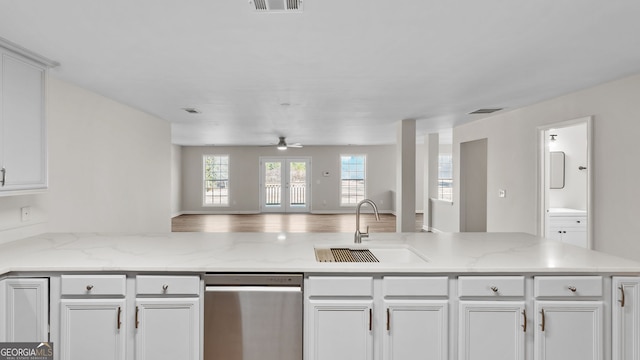 kitchen featuring french doors, sink, ceiling fan, light stone counters, and white cabinets