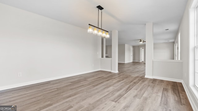 unfurnished dining area featuring ceiling fan and light wood-type flooring