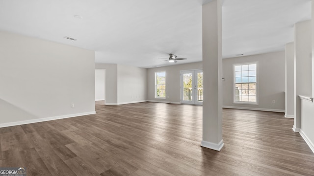 unfurnished living room with dark wood-type flooring and ceiling fan