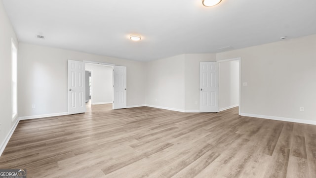 spare room featuring light wood-type flooring