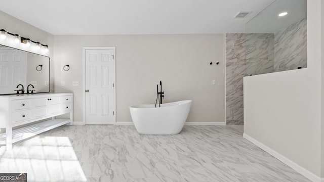 bathroom with a tub and vanity