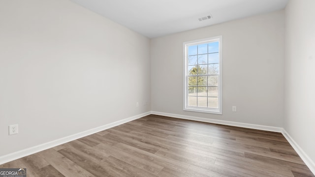 spare room featuring hardwood / wood-style flooring