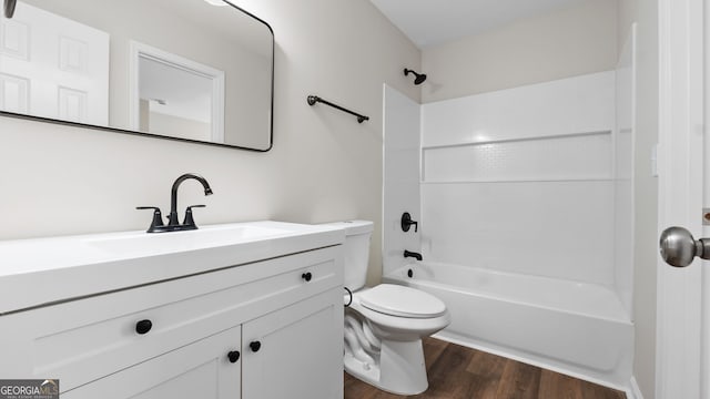 full bathroom featuring toilet, vanity, hardwood / wood-style floors, and shower / tub combination