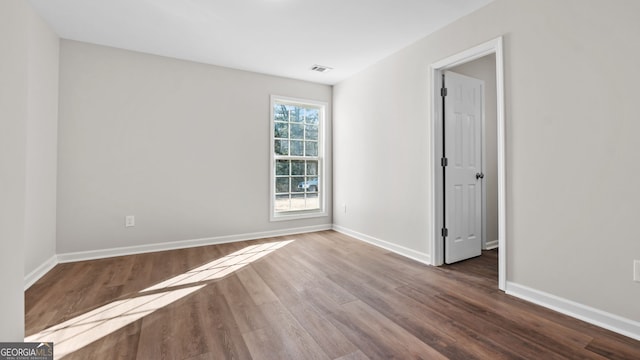 spare room with hardwood / wood-style flooring