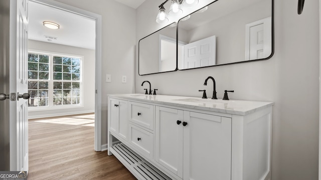 bathroom with hardwood / wood-style flooring and vanity