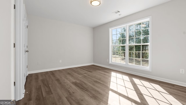 spare room with dark wood-type flooring