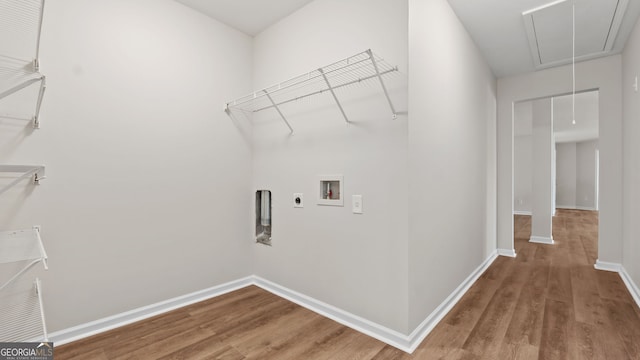 clothes washing area featuring hardwood / wood-style floors, hookup for an electric dryer, and washer hookup