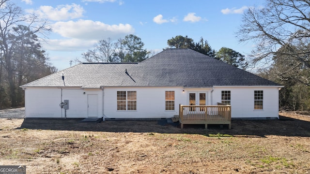 back of house with a wooden deck, french doors, and a lawn