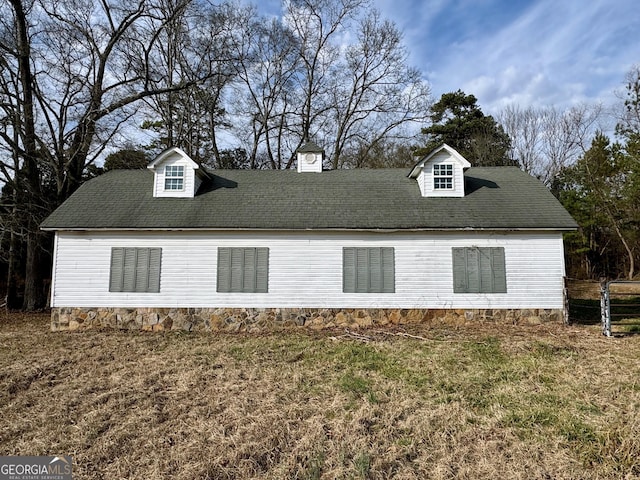 view of side of property with a lawn