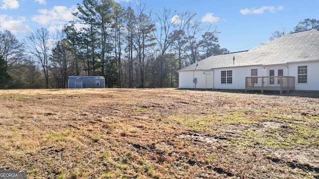 view of yard featuring a shed and a deck