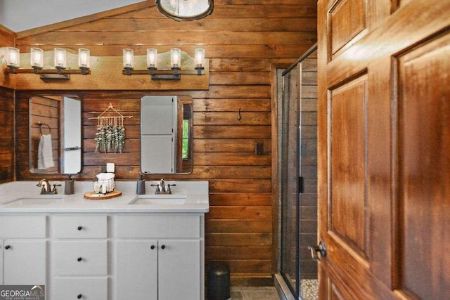 bathroom featuring a shower with shower door, vanity, lofted ceiling, and log walls