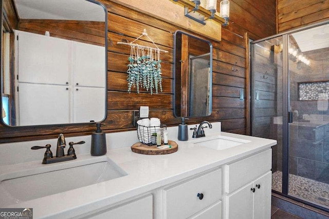 bathroom with vanity, walk in shower, and wooden walls