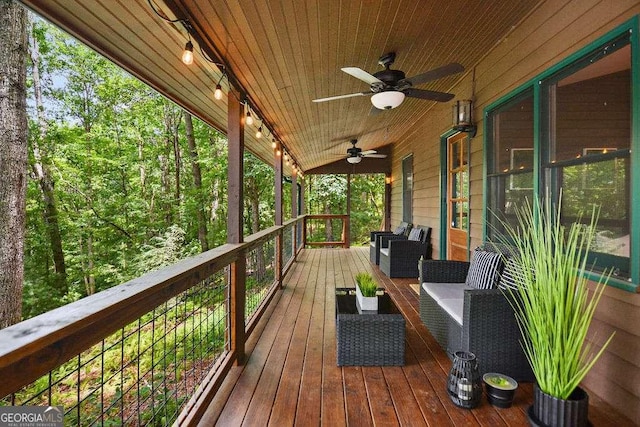 wooden deck featuring ceiling fan and outdoor lounge area