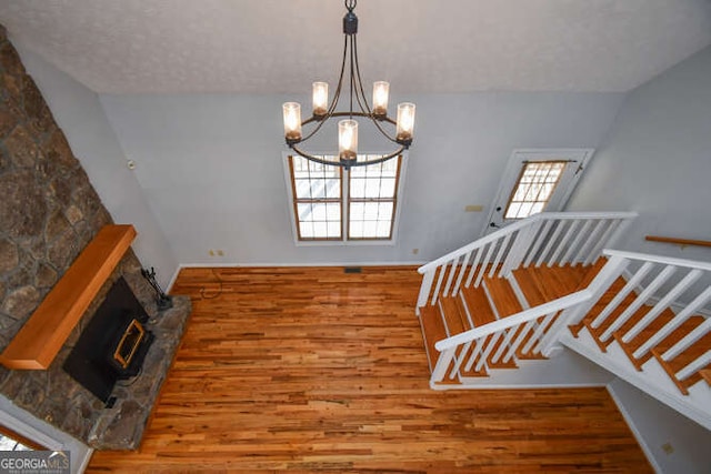 staircase featuring a chandelier and hardwood / wood-style floors