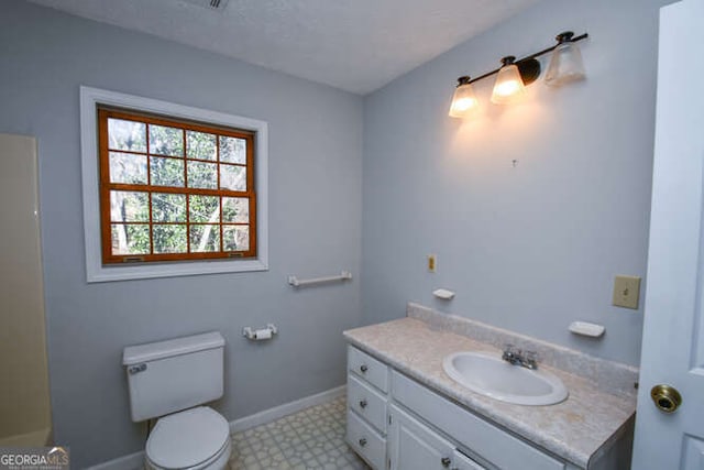 bathroom with toilet and vanity