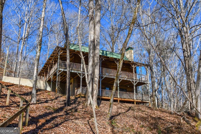 rear view of house with a wooden deck