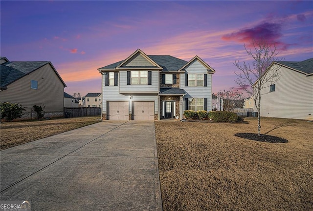 front facade with a garage and a lawn