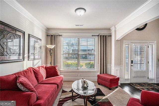 living room with wood-type flooring and crown molding