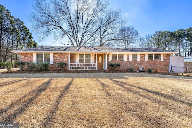 ranch-style home with a front yard and a porch