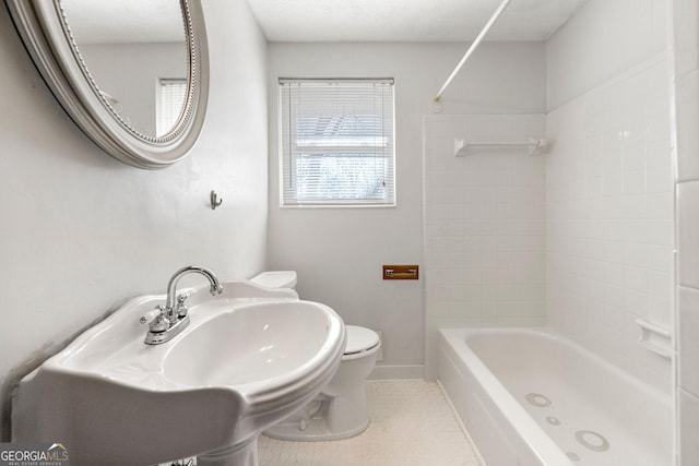 bathroom featuring washtub / shower combination and toilet