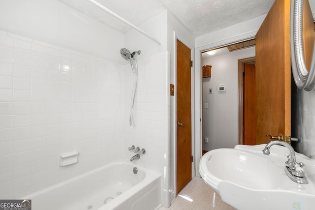 bathroom with shower / bath combination, tile patterned flooring, and a textured ceiling