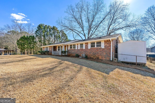 ranch-style house featuring a front yard and a porch