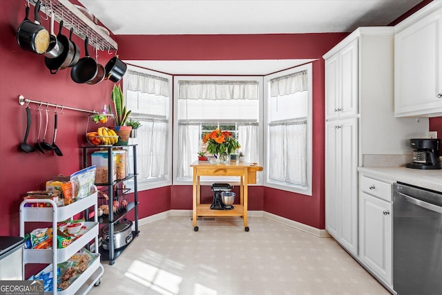 kitchen with dishwasher and white cabinets