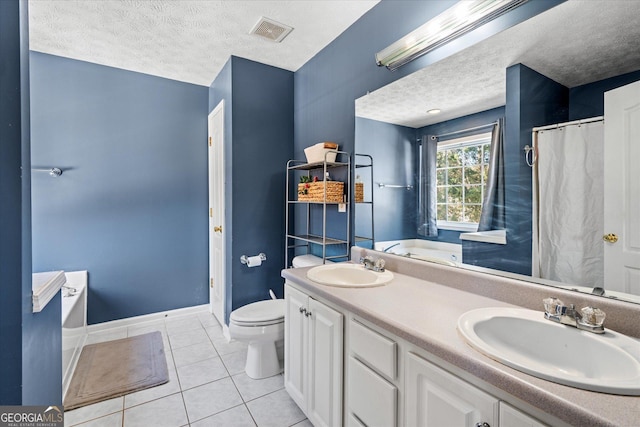 bathroom featuring a textured ceiling, toilet, tile patterned floors, and vanity