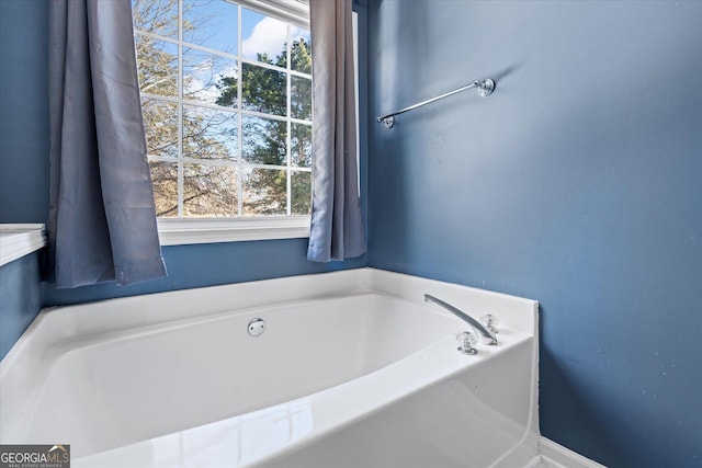 bathroom with a bathing tub and a wealth of natural light