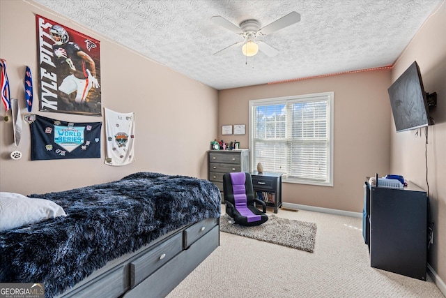 bedroom featuring ceiling fan, light colored carpet, and a textured ceiling