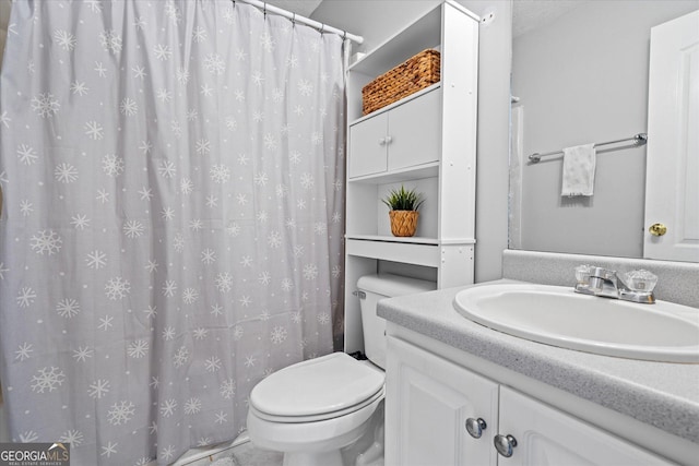 bathroom featuring toilet, vanity, and a textured ceiling