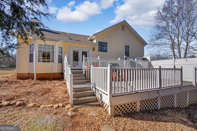 rear view of house featuring a wooden deck