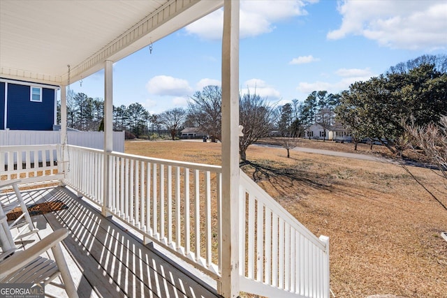 wooden terrace featuring covered porch