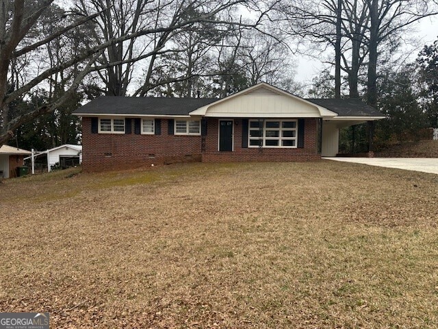 ranch-style house with a front lawn and a carport