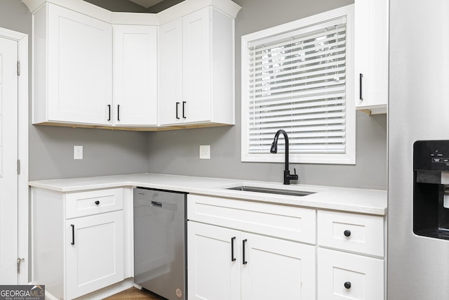 kitchen featuring white cabinetry, sink, and stainless steel dishwasher