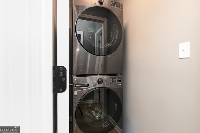 laundry room with stacked washer / dryer