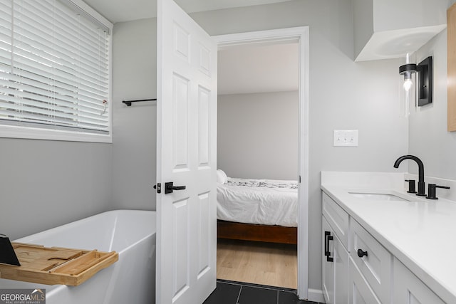 bathroom featuring vanity and a tub