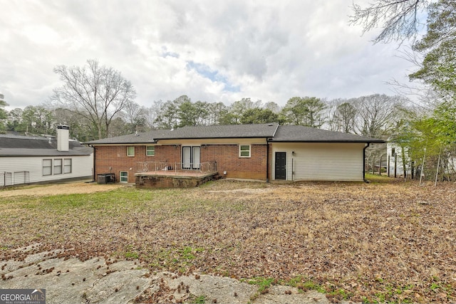 back of house featuring central AC unit