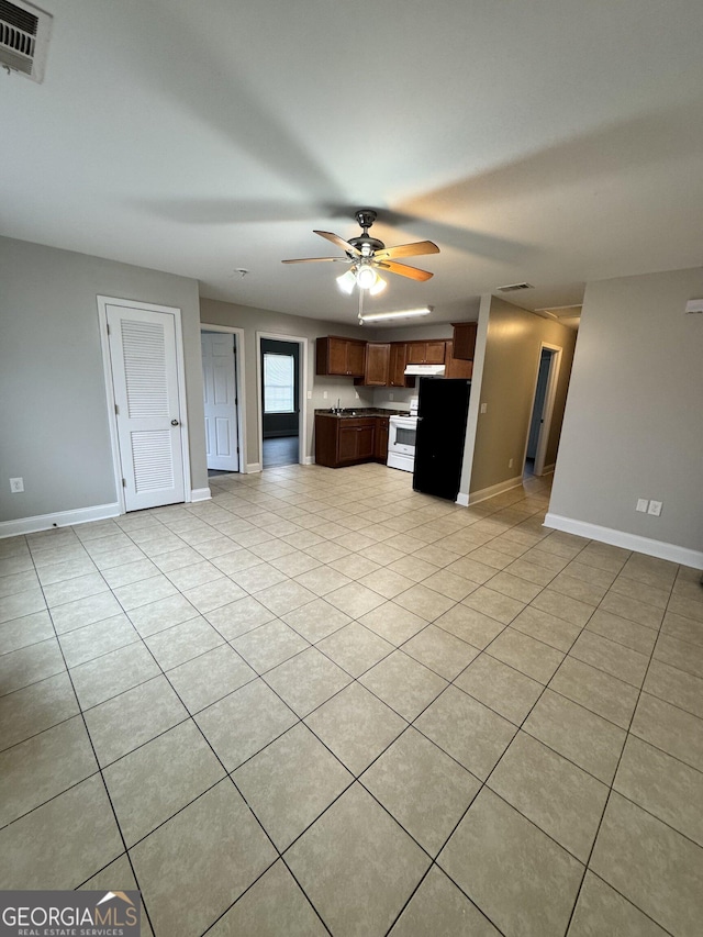 kitchen featuring ceiling fan, electric stove, and light tile patterned floors