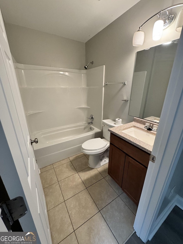 full bathroom featuring toilet, tile patterned flooring, washtub / shower combination, and vanity